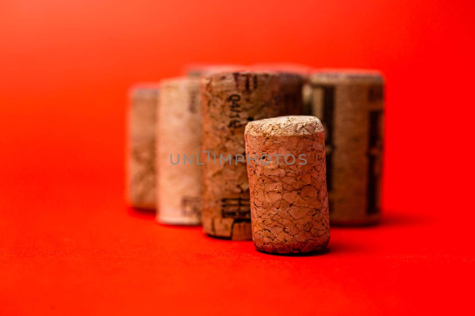 lots of wine corks on a red background. by Pukhovskiy