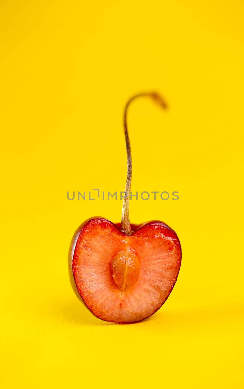 cherry in a close-up section on a yellow background.