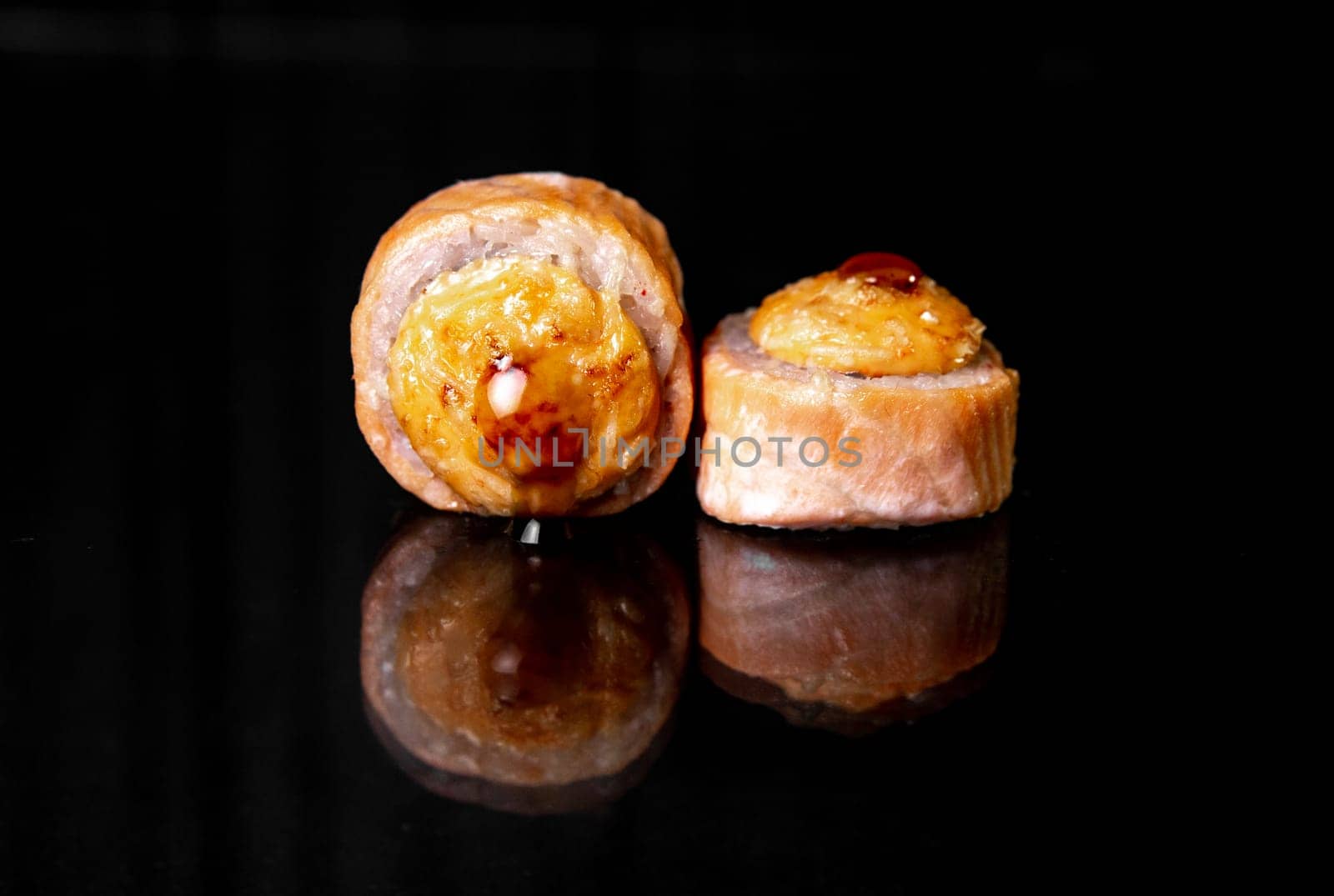 rolls with reflection on black background. photo for menu design. by Pukhovskiy