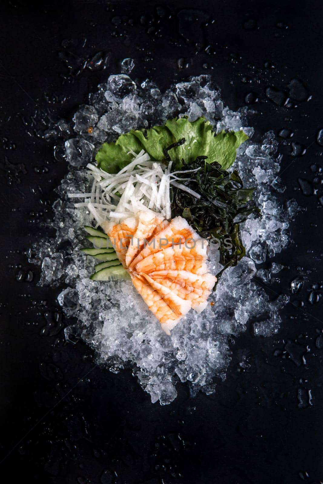 fish and tuna on ice on black background.