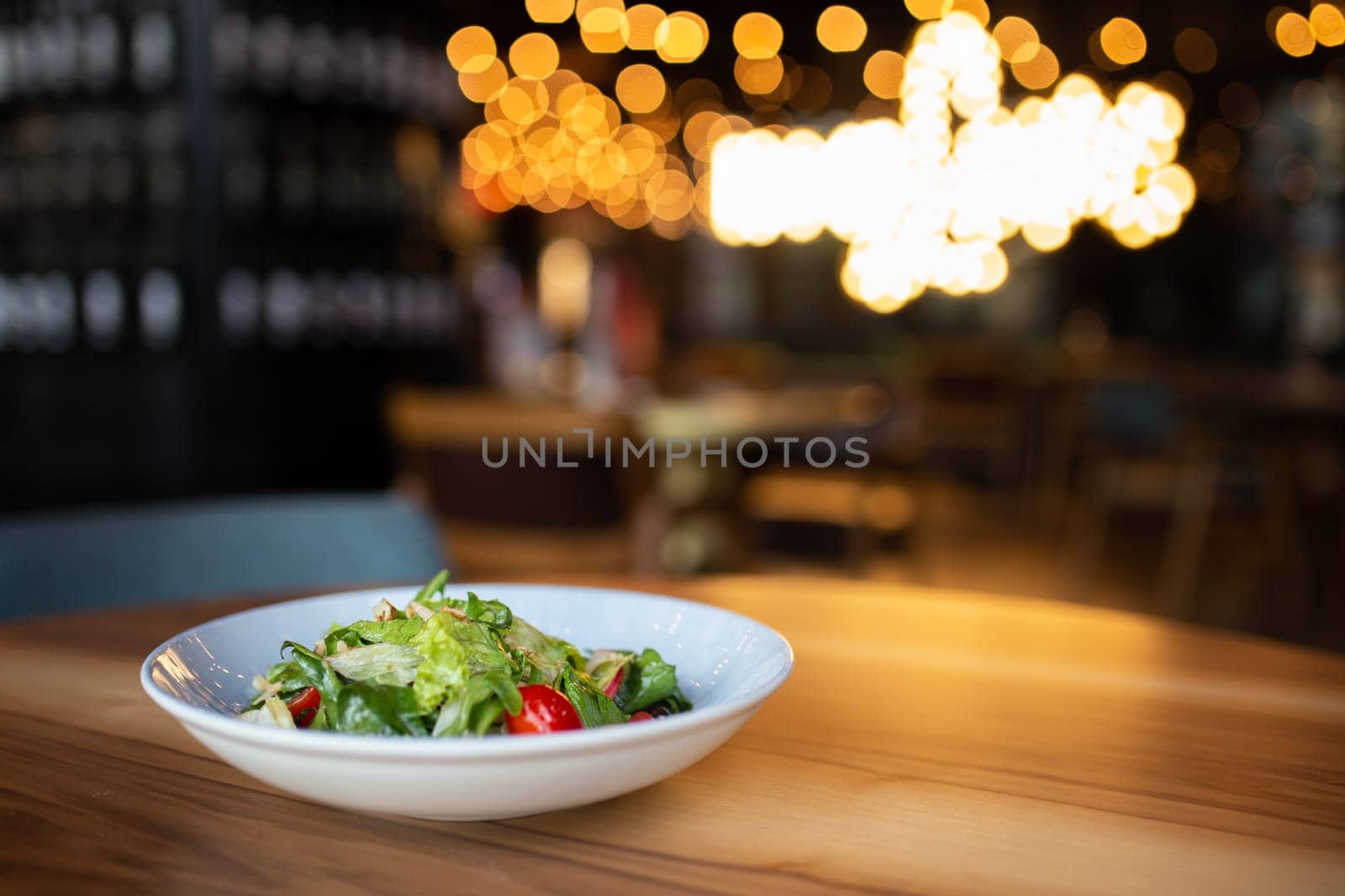 light summer salad of vegetables with herbs in cafes. by Pukhovskiy