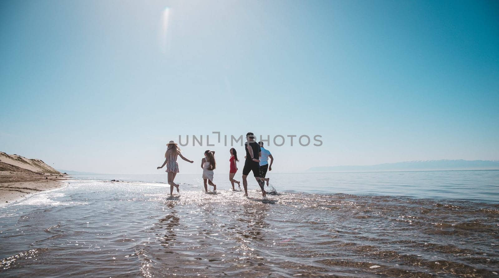 company running along the shore on a summer day.