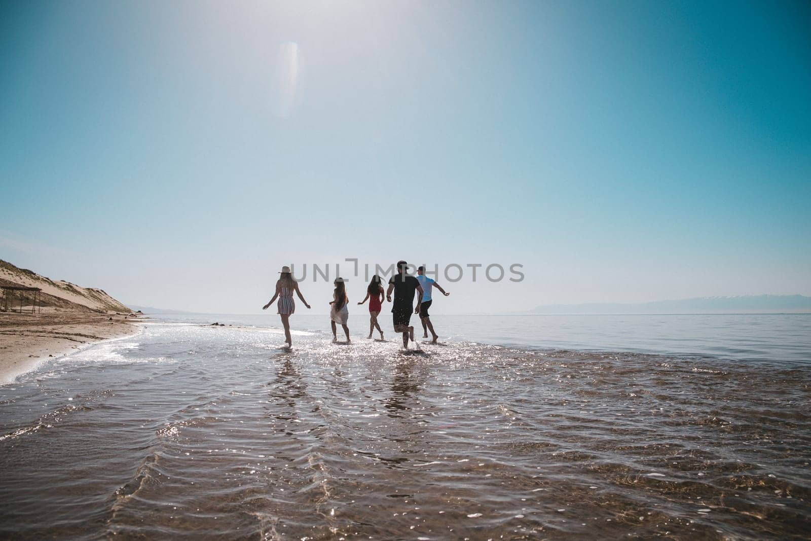 company running along the shore on a summer day by Pukhovskiy