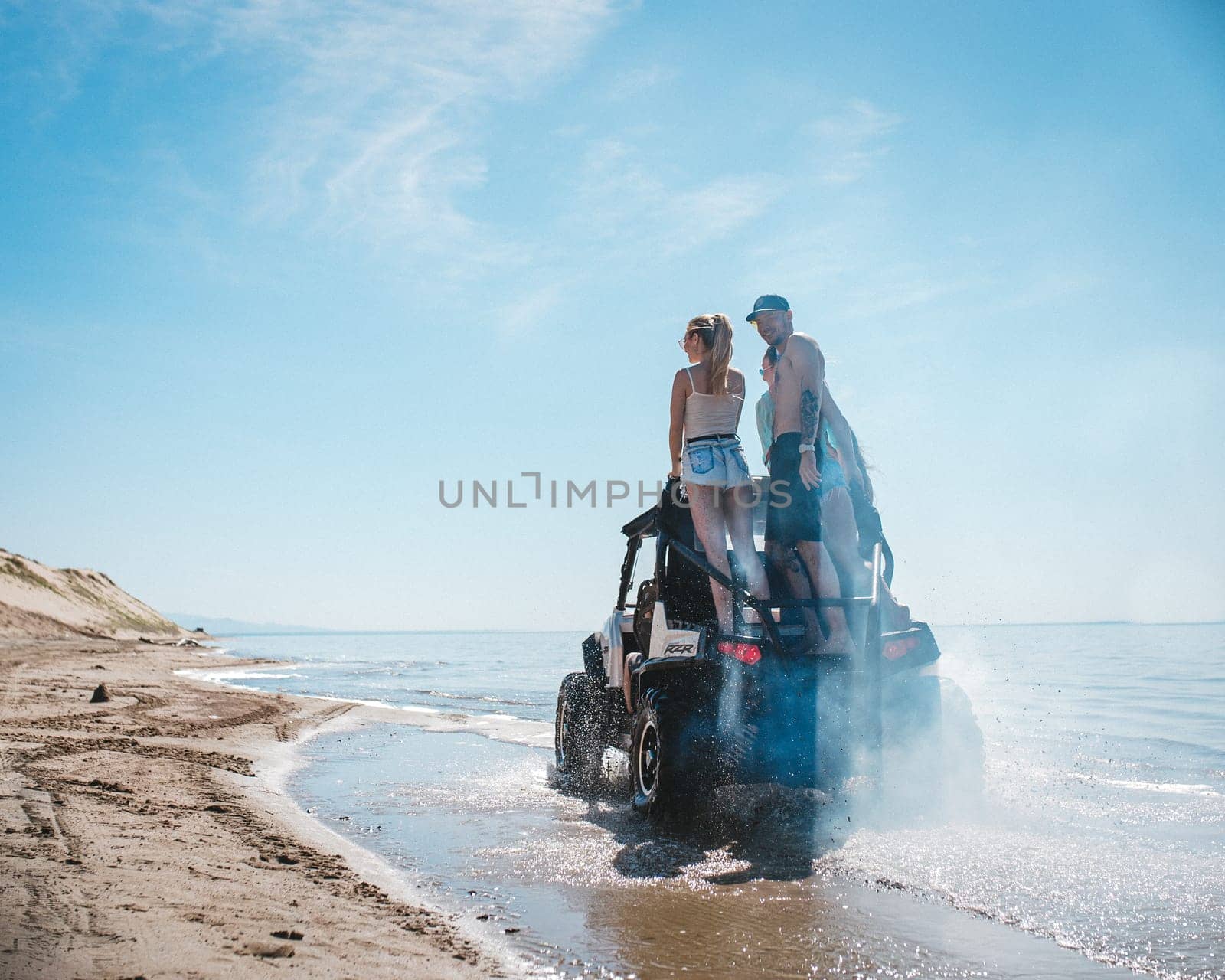 quad bike with people rides on the shore