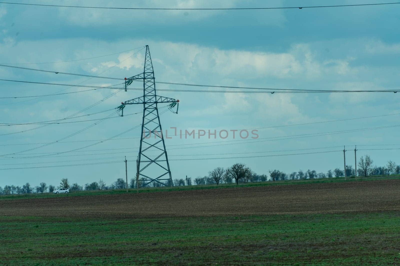 High voltage towers with sky background. Power line support with wires for electricity transmission. High voltage grid tower with wire cable at distribution station. Energy industry, energy saving by Matiunina