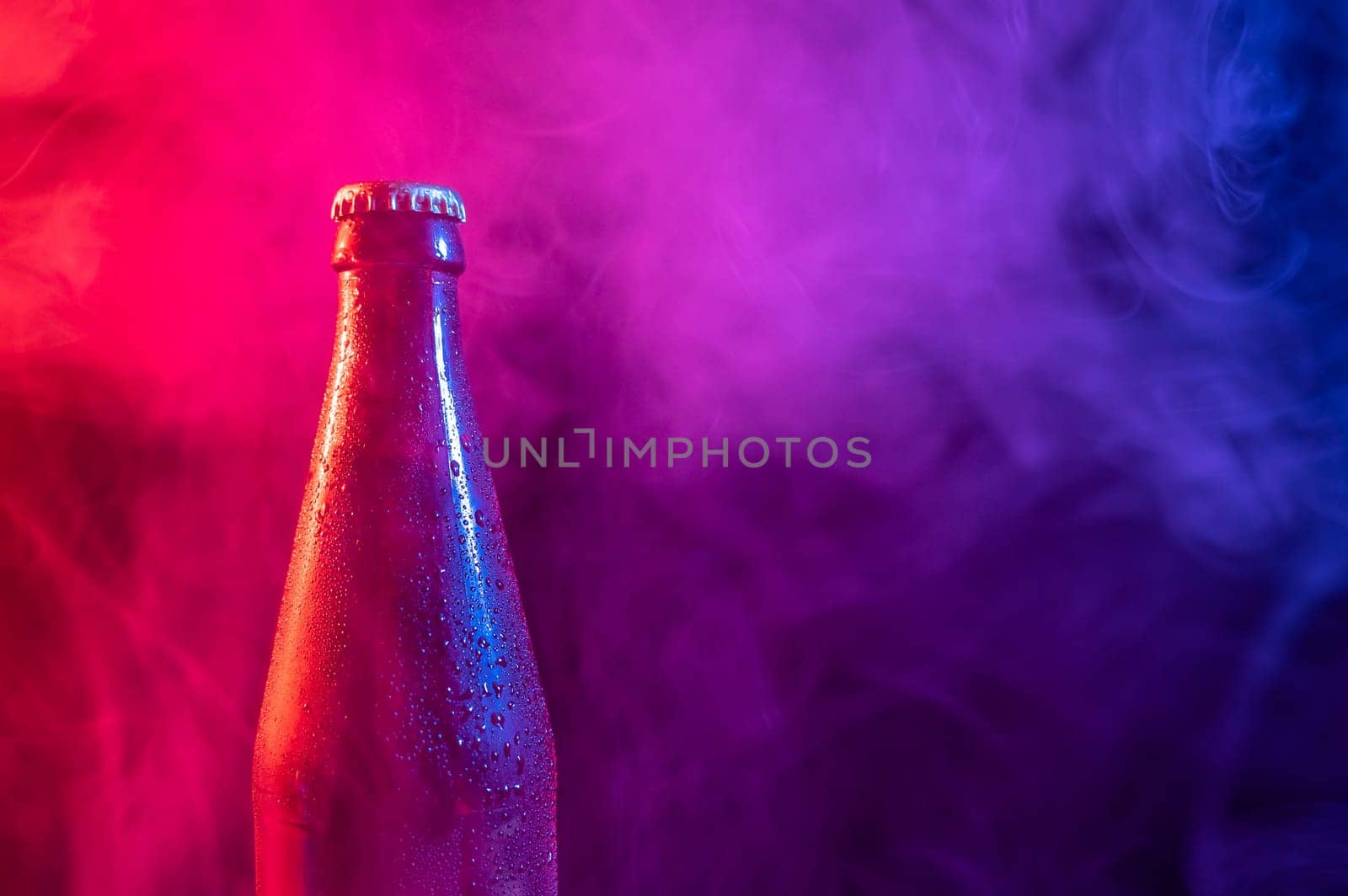 Glass bottle of beer in blue pink mist by mrwed54