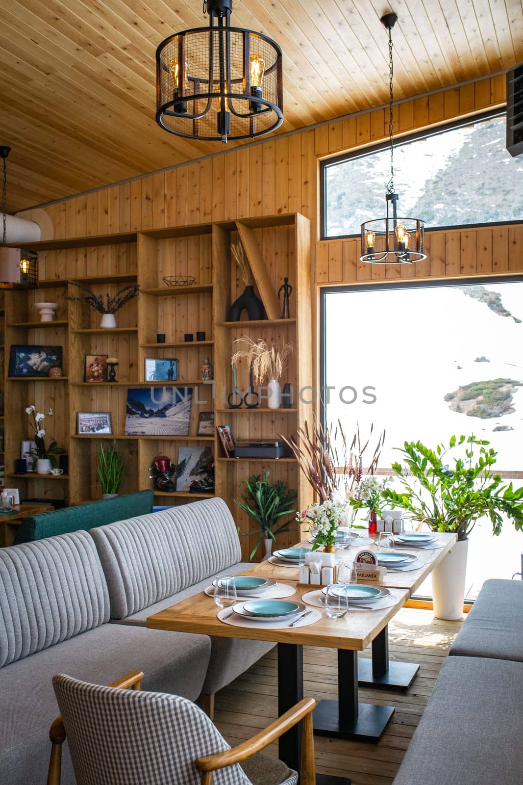 Cozy mountain restaurant with wood paneling and large windows by Pukhovskiy