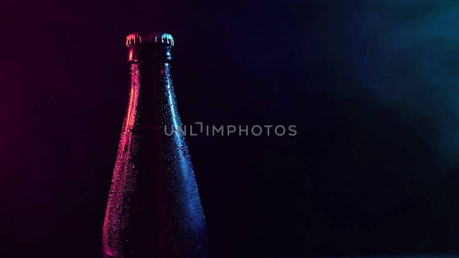 Beer bottle spinning in blue pink smoke. by mrwed54