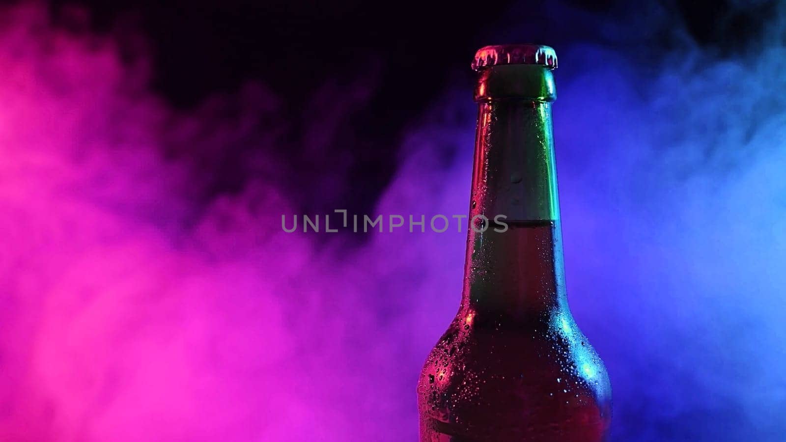 Beer bottle spinning in blue pink smoke