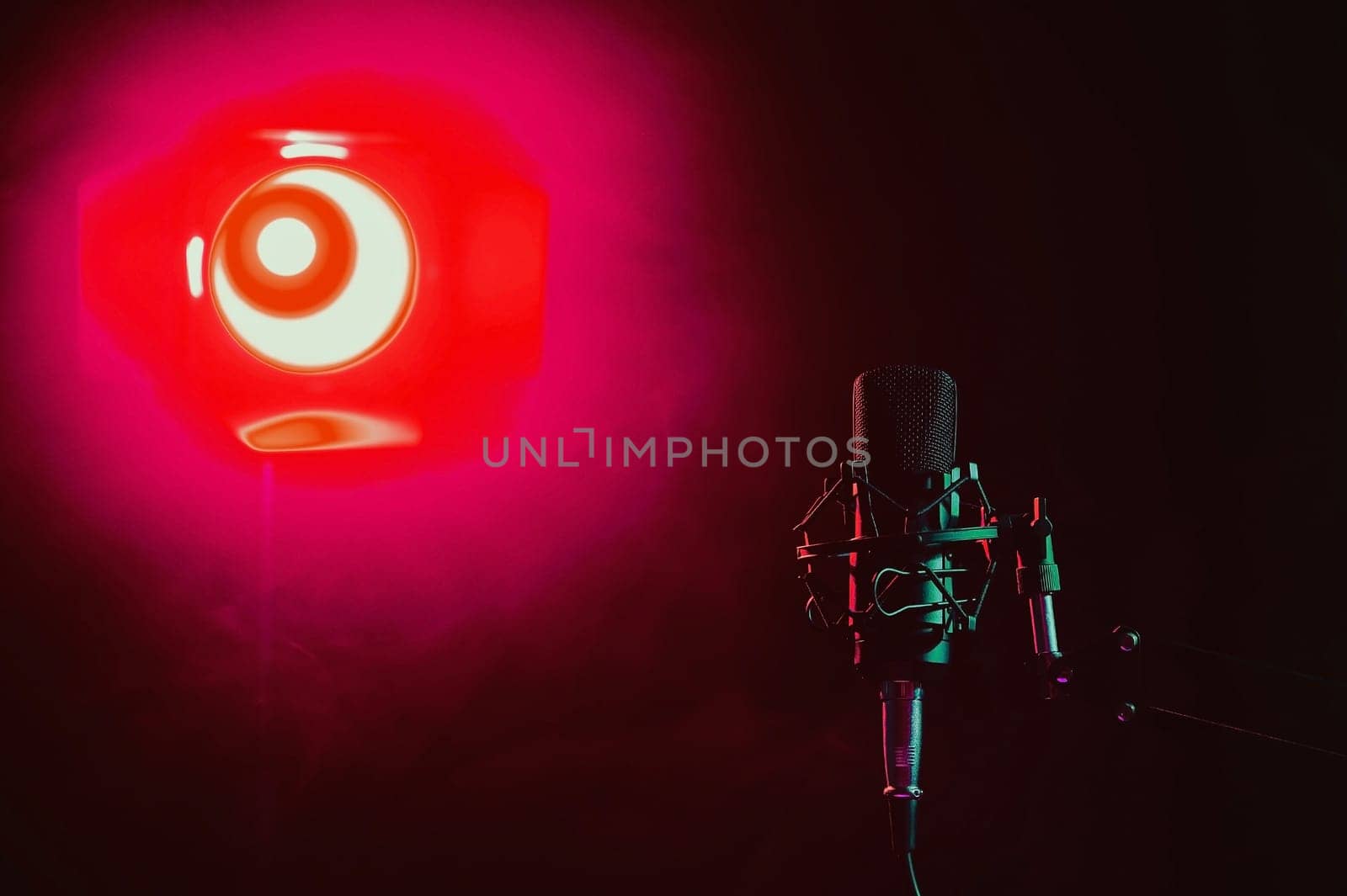 Professional microphone in red smoke on a black background. by mrwed54