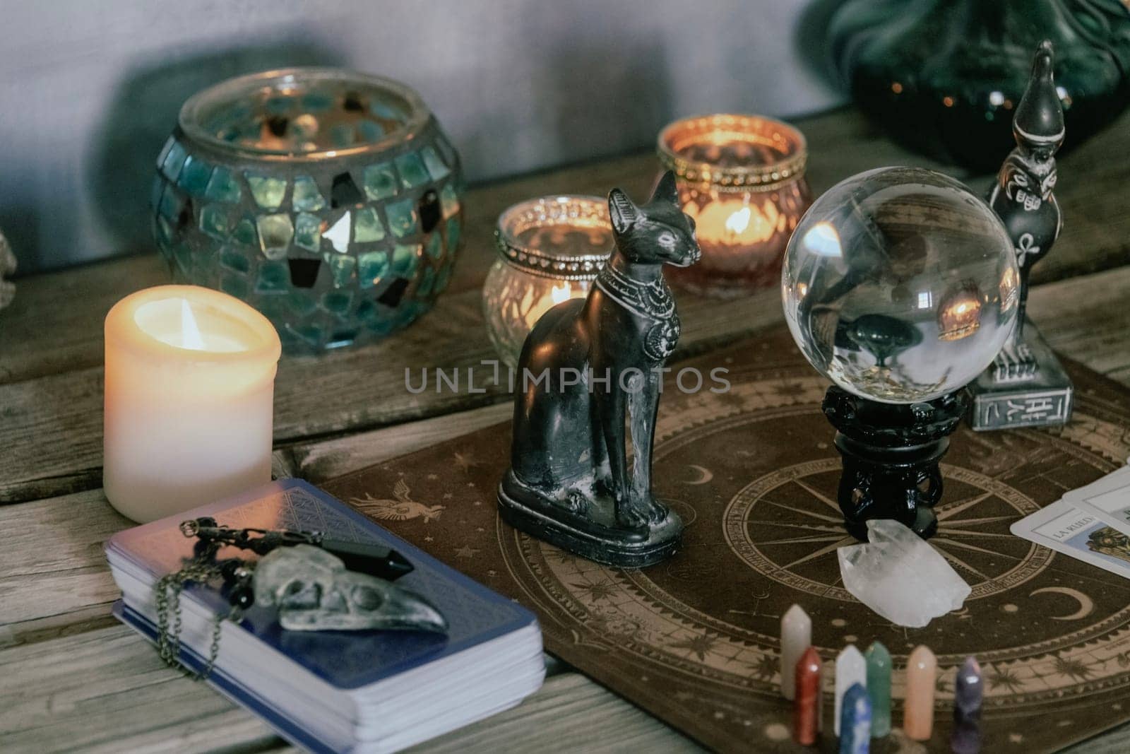 An atmospheric setting featuring a crystal ball, Egyptian cat statues, candles, and crystals, creating a mystical ambiance. by jbruiz78