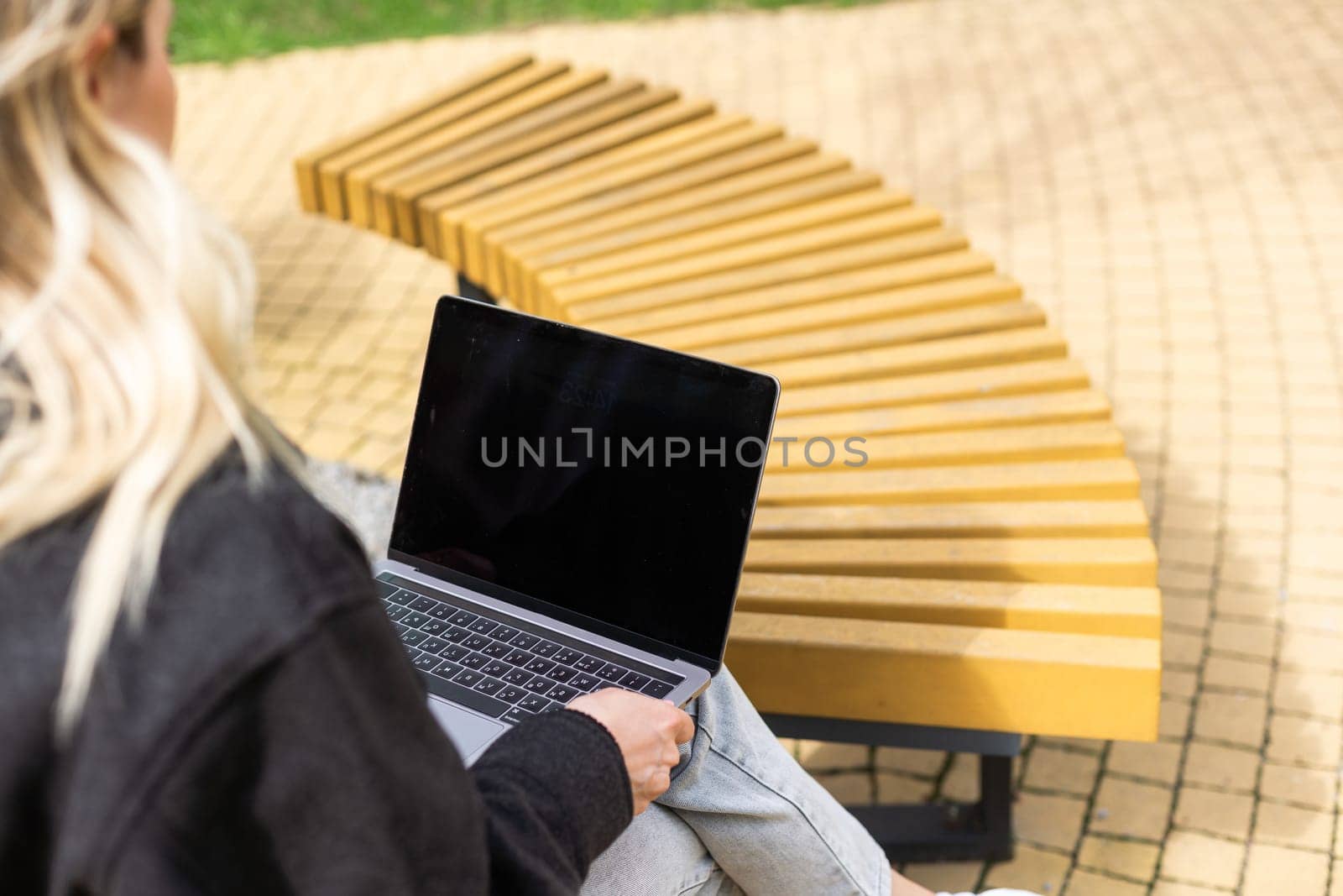 Businesswoman working with laptop in outdoor cafe. Corporate blog by Andelov13