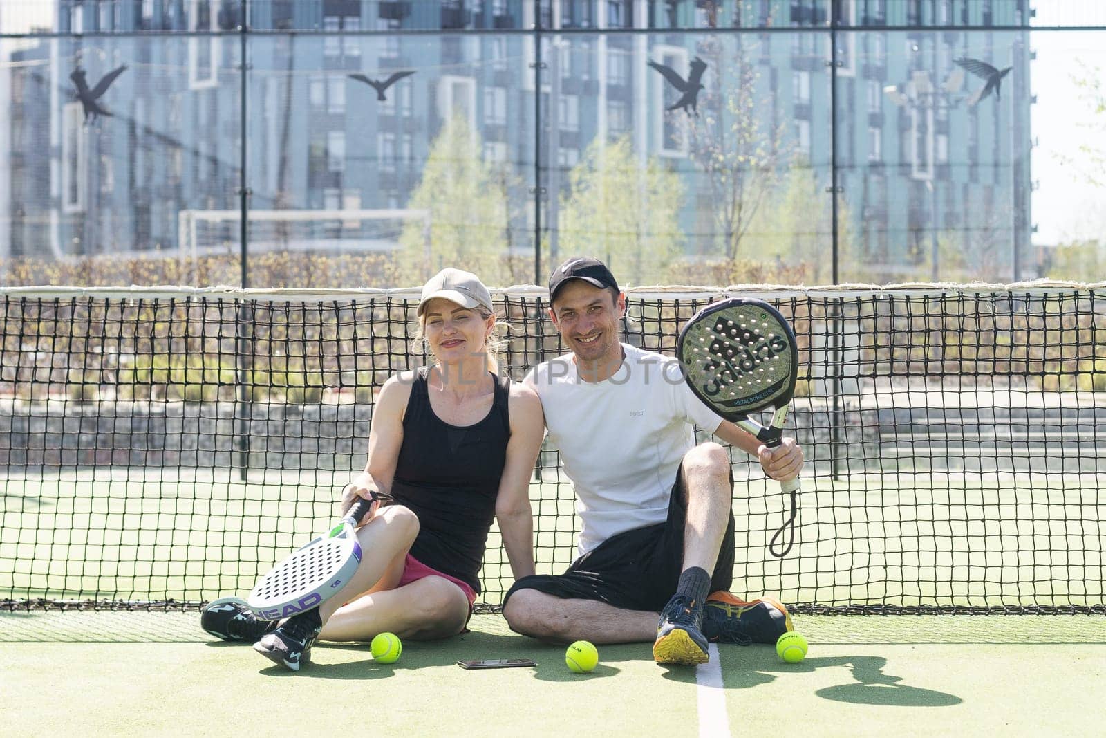 Ukraine Kyiv, April 02 2024. Padel training coach in a session, mentoring a female student, fostering skill development and a positive learning environment by Andelov13