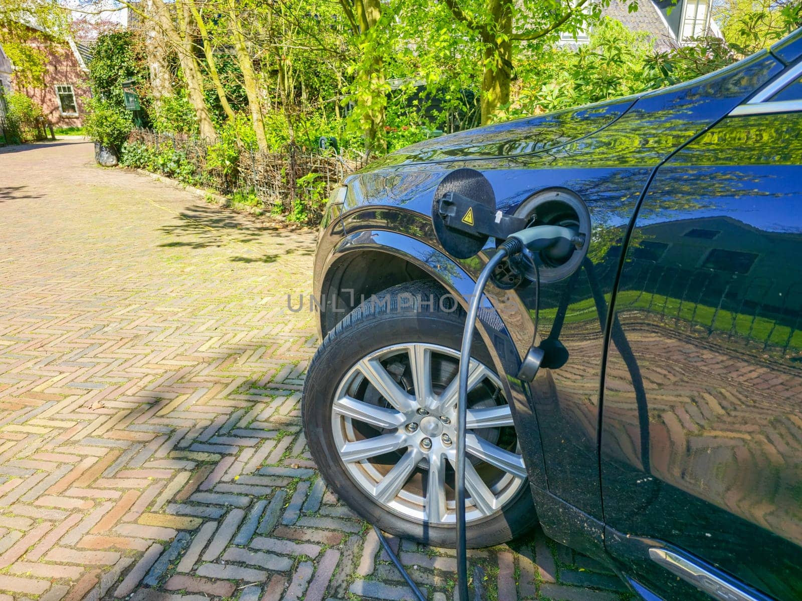 EV car charging,electric car in the concept of green energy and eco power produced from sustainable source to supply to charger stations in order to reduce CO2 emission in the Netherlands