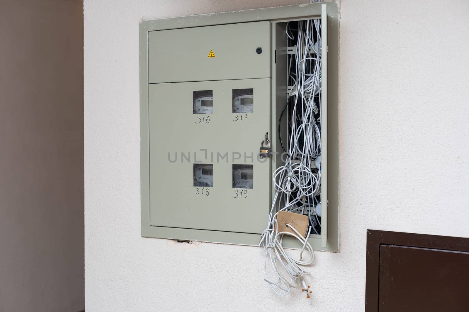 Electric cabinet with Internet and television cables in an apartment building. Niche for wires and cables inside the wall by Andelov13