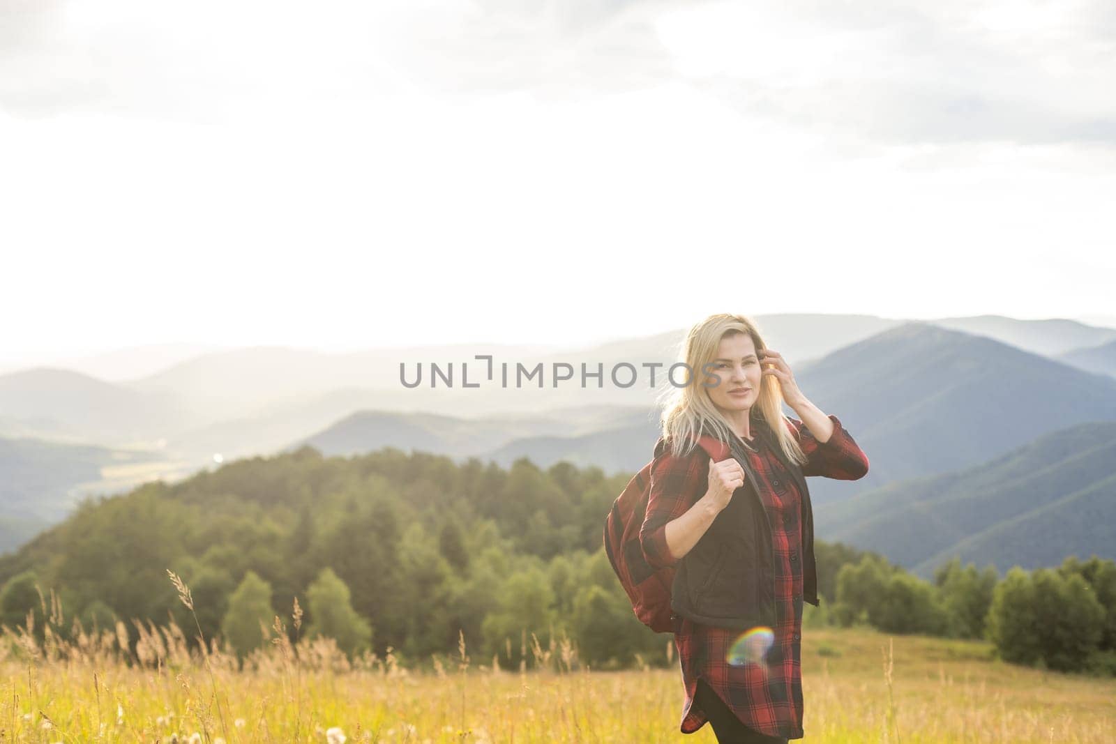 Girl Traveler hiking with backpack at rocky mountains landscape Travel Lifestyle concept adventure summer vacations outdoor. by Andelov13