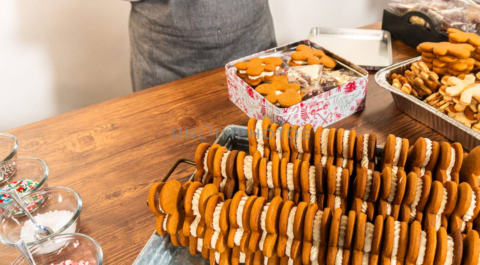 Making Festive Gingerbread Sandwiches on Rustic Wooden Table by arinahabich