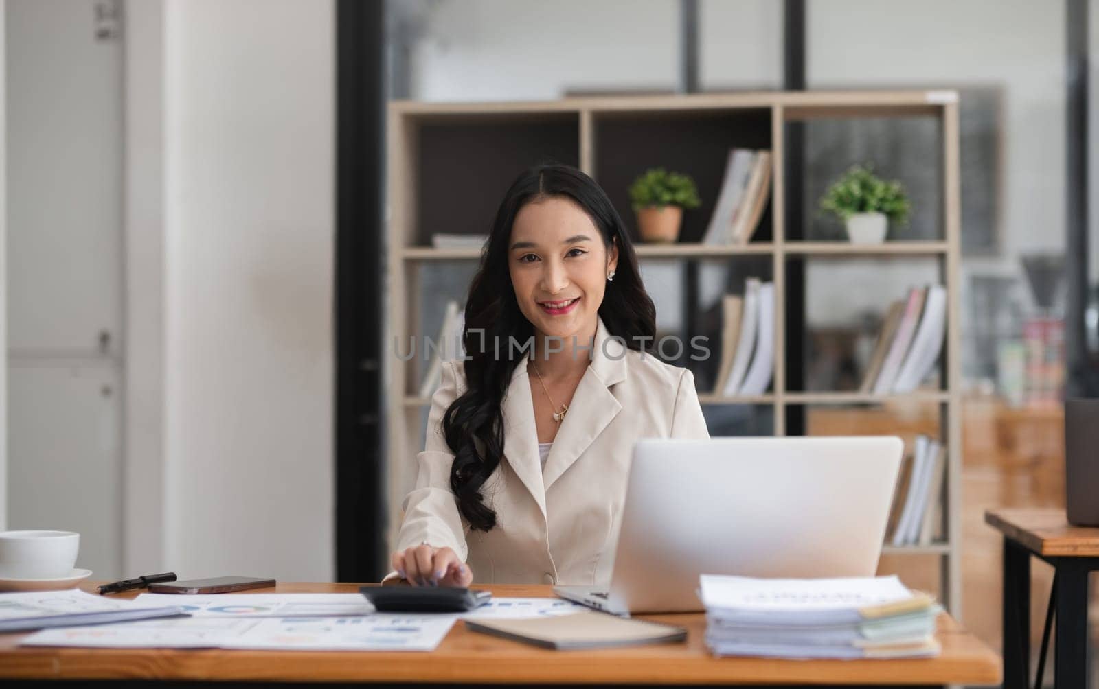 Asian businesswoman working online and planning financial calculation data working from home. Businesswoman and business planner concept by wichayada