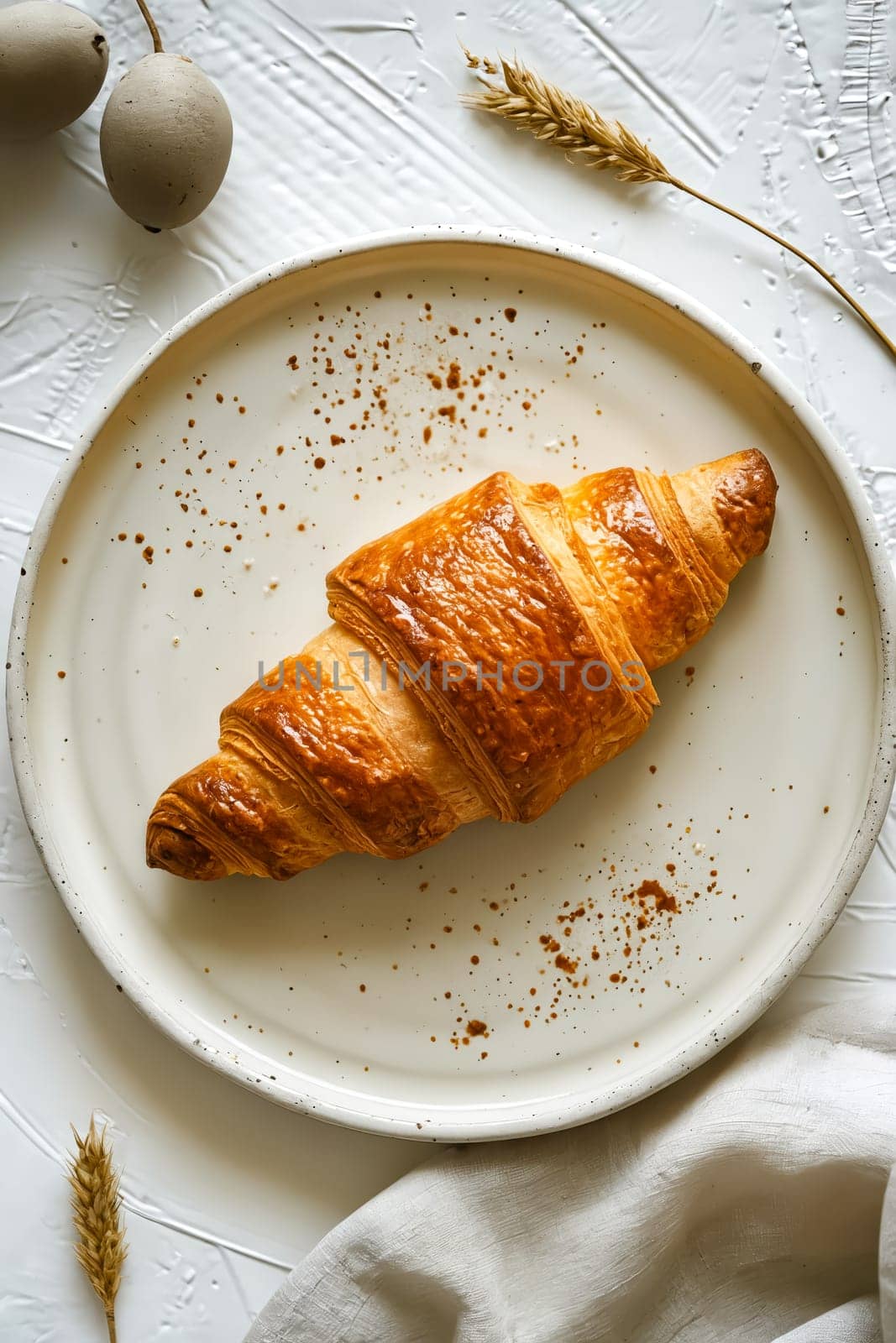 Croissant on plate with wheat and napkin. Generative AI.