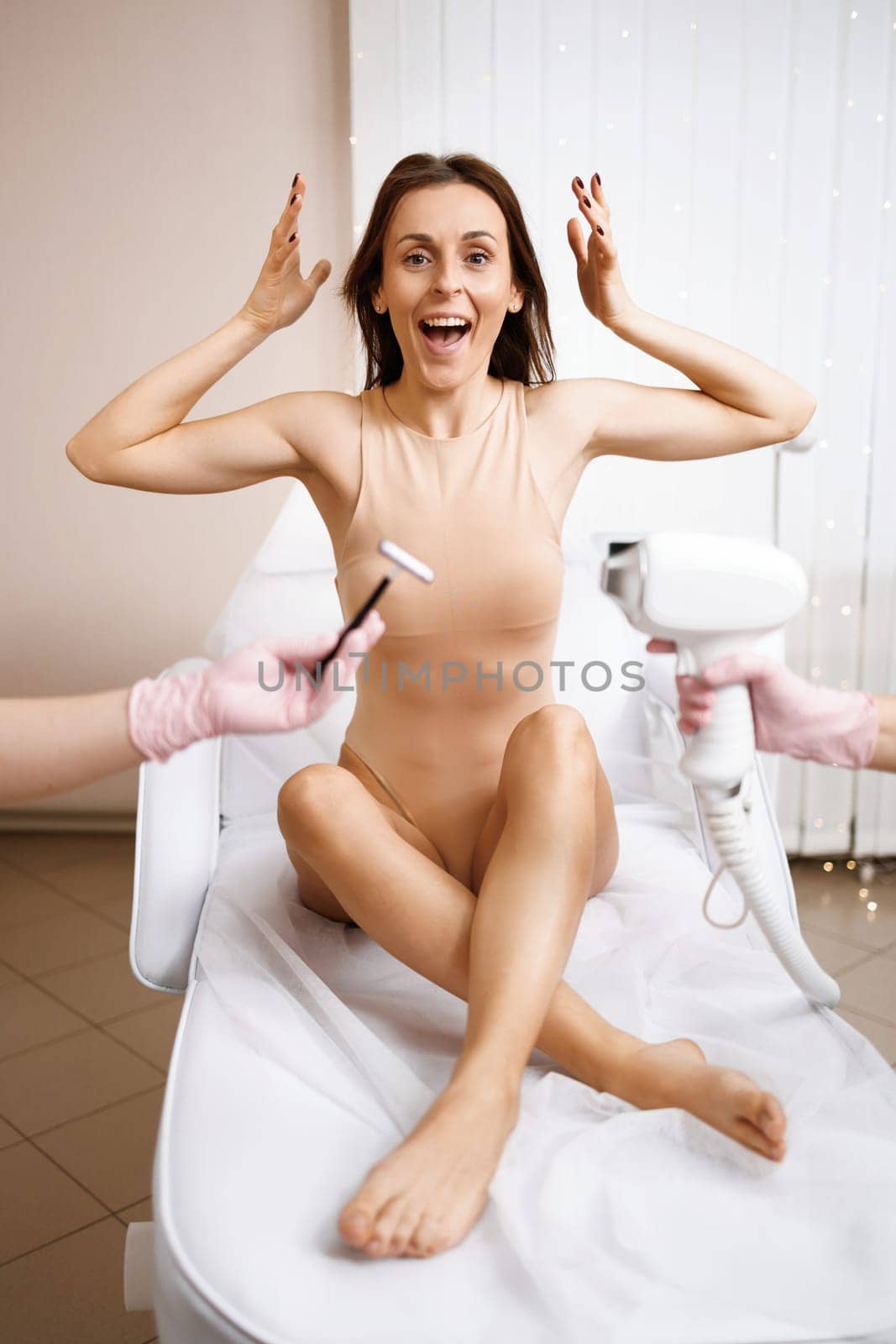 Laser epilator vs shaving razor. Cosmetologist holds in hand equipment for laser hair removal and razors in the other hand over brunette woman. Laser hair removal.