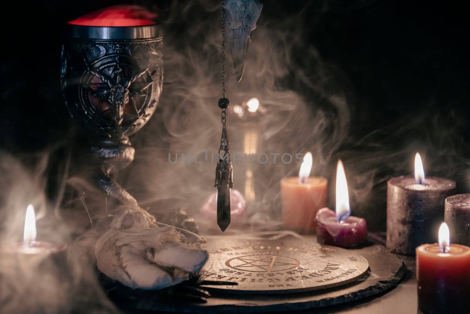 A mysterious and atmospheric occult setting featuring a pendulum swinging over a mystic symbol, surrounded by candlelight and fog. by jbruiz78