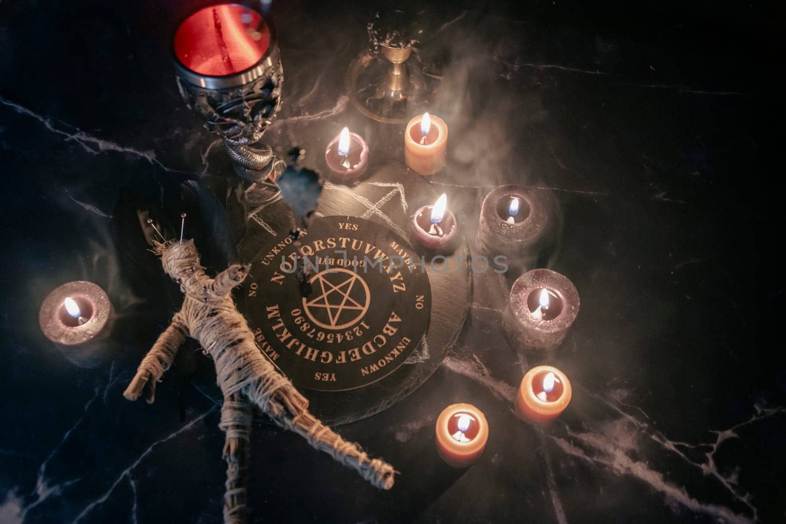 A chilling scene of an occult ritual featuring a voodoo doll pinned with needles, surrounded by candles, a pentagram, and eerie smoke. by jbruiz78