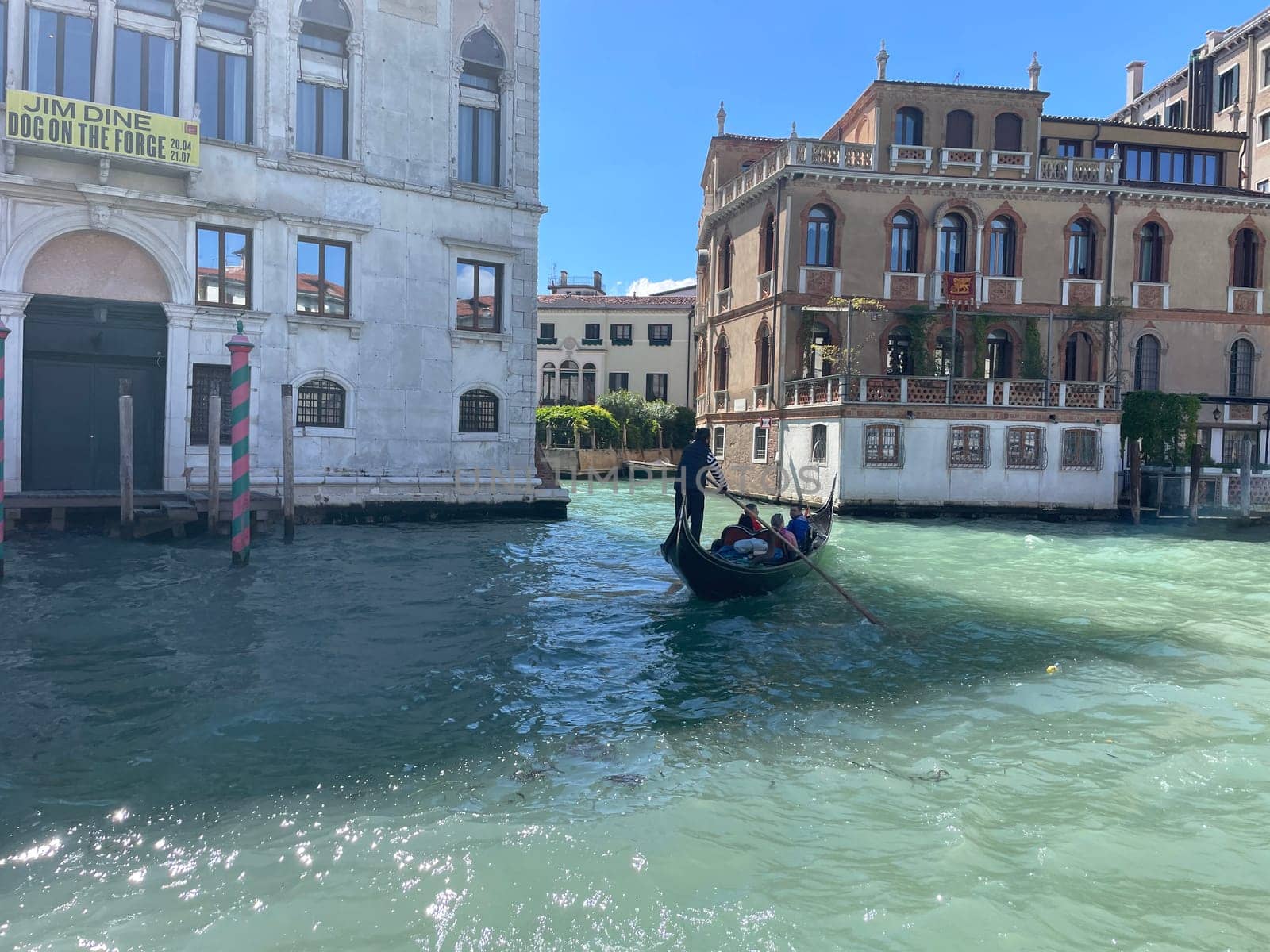 Italy, Venice, April 25, 2024, Gondoliers on gondolas carry tourists. High quality photo
