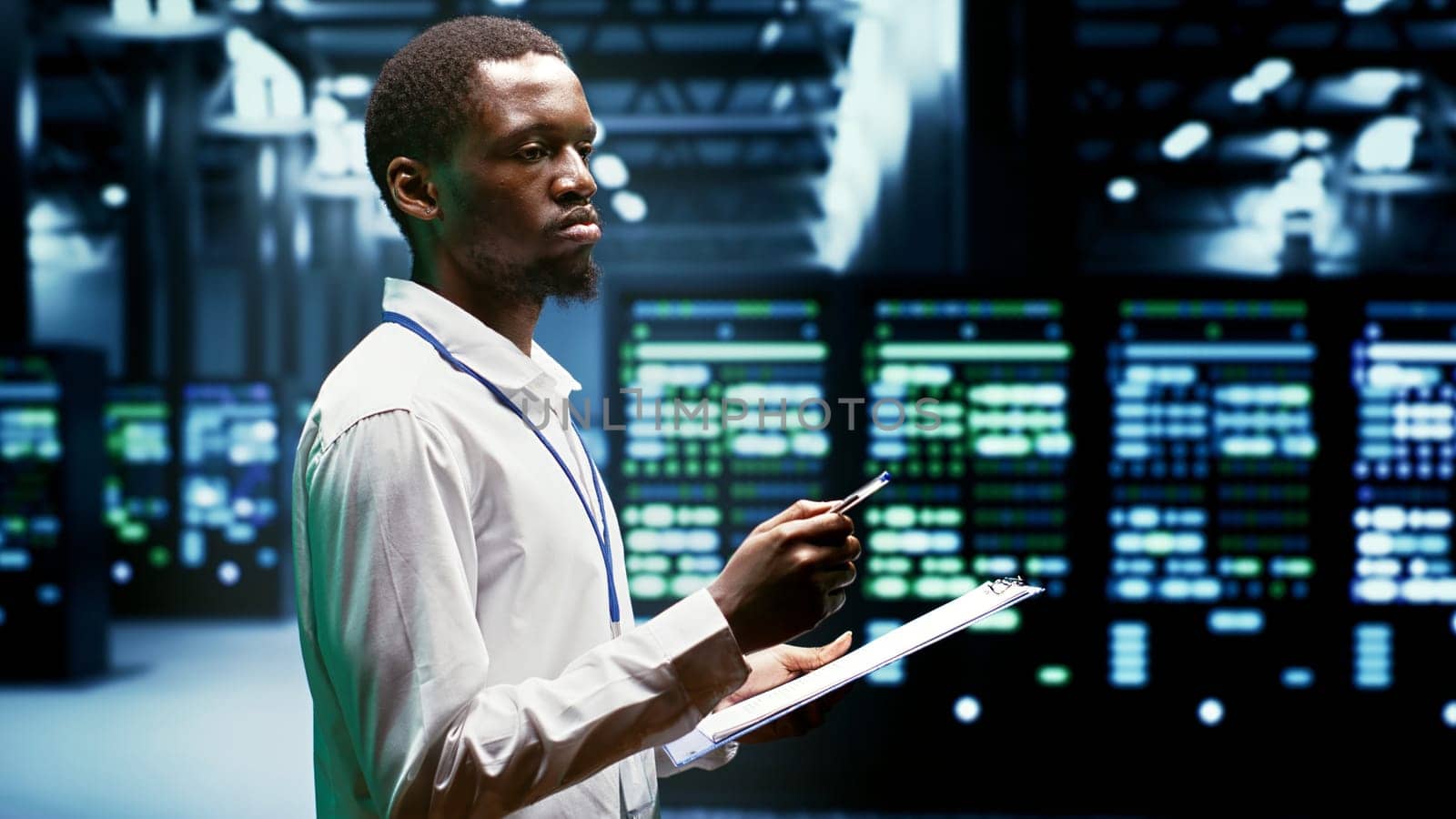 IT programmer using clipboard to assess supercomputer cybersecurity dangers arising due to unsecured network connections. Supervisor making sure high tech facility is invulnerable to malware attacks