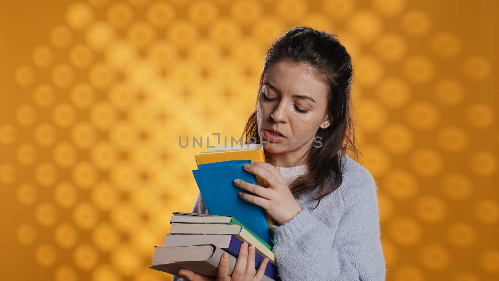 Excited woman browsing though pile of books, picking what to read by DCStudio