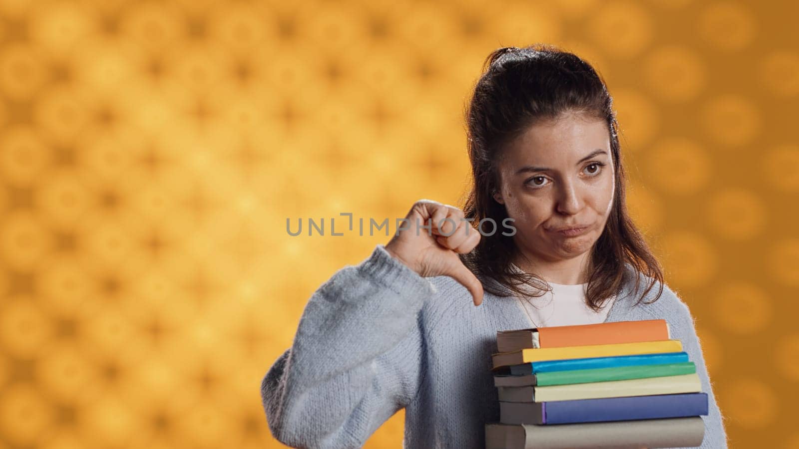 Sulky lady with stack of novels doing thumbs down hand gesturing by DCStudio