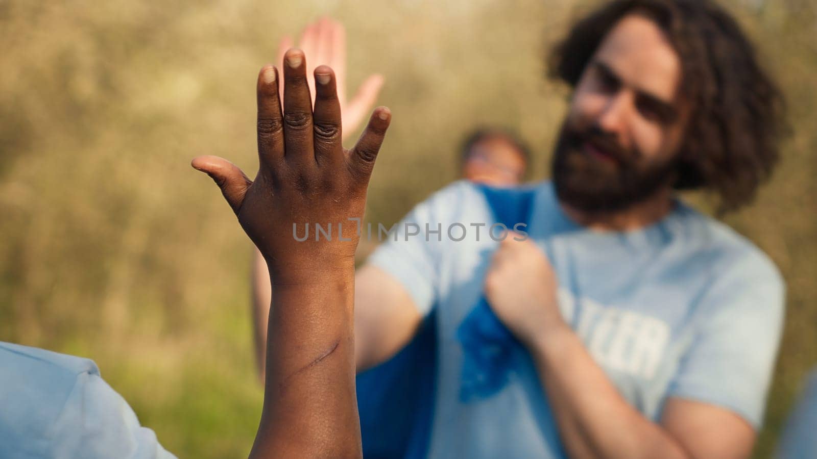 Team leader sharing a high five with her volunteers members after litter cleanup by DCStudio