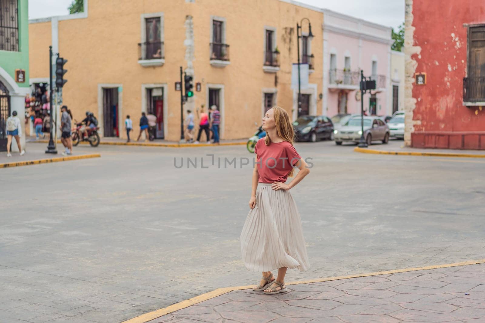 Woman tourist explores the vibrant streets of Valladolid, Mexico, immersing herself in the rich culture and colorful architecture of this charming colonial town by galitskaya