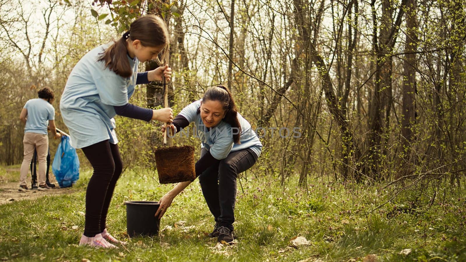 Mother and daughter team up to plant new trees in the woods by DCStudio