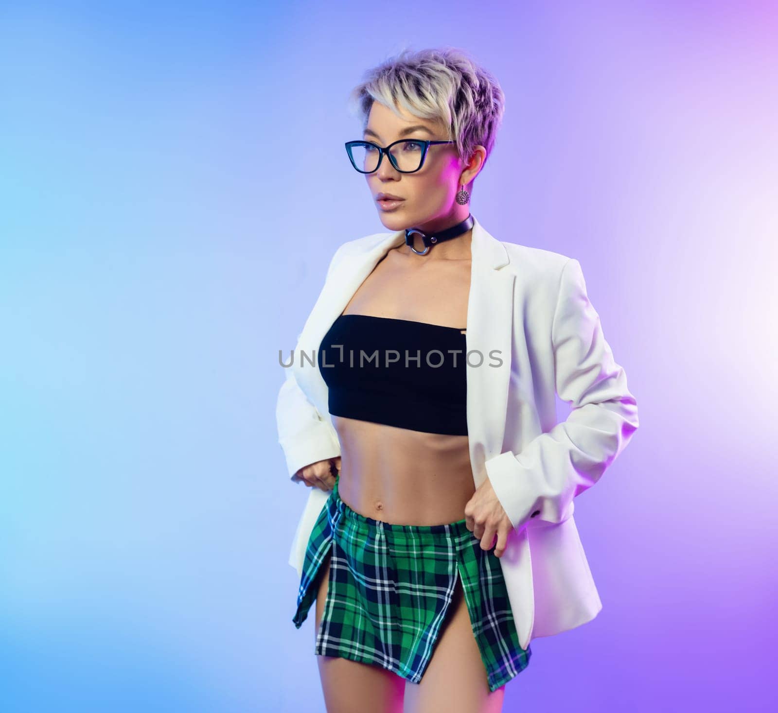 Sexy girl with glasses and a white jacket with a plaid skirt in neon light on a background of copy paste by Rotozey