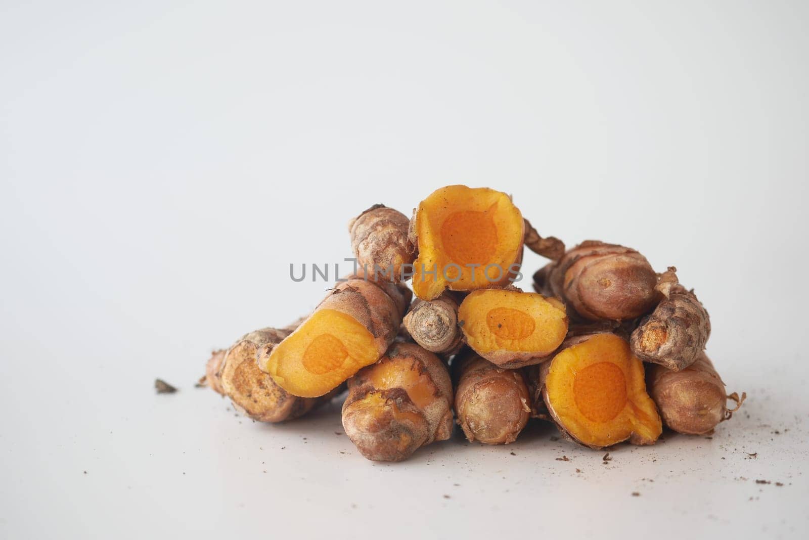 detail shot of turmeric root in bowl on table , by towfiq007