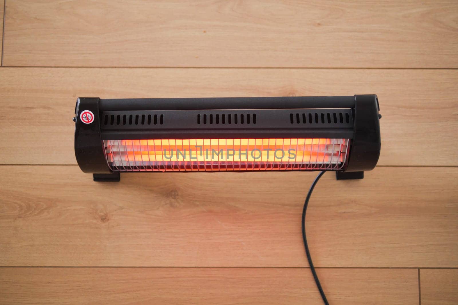 Modern electric infrared heater in living room, closeup. High quality photo