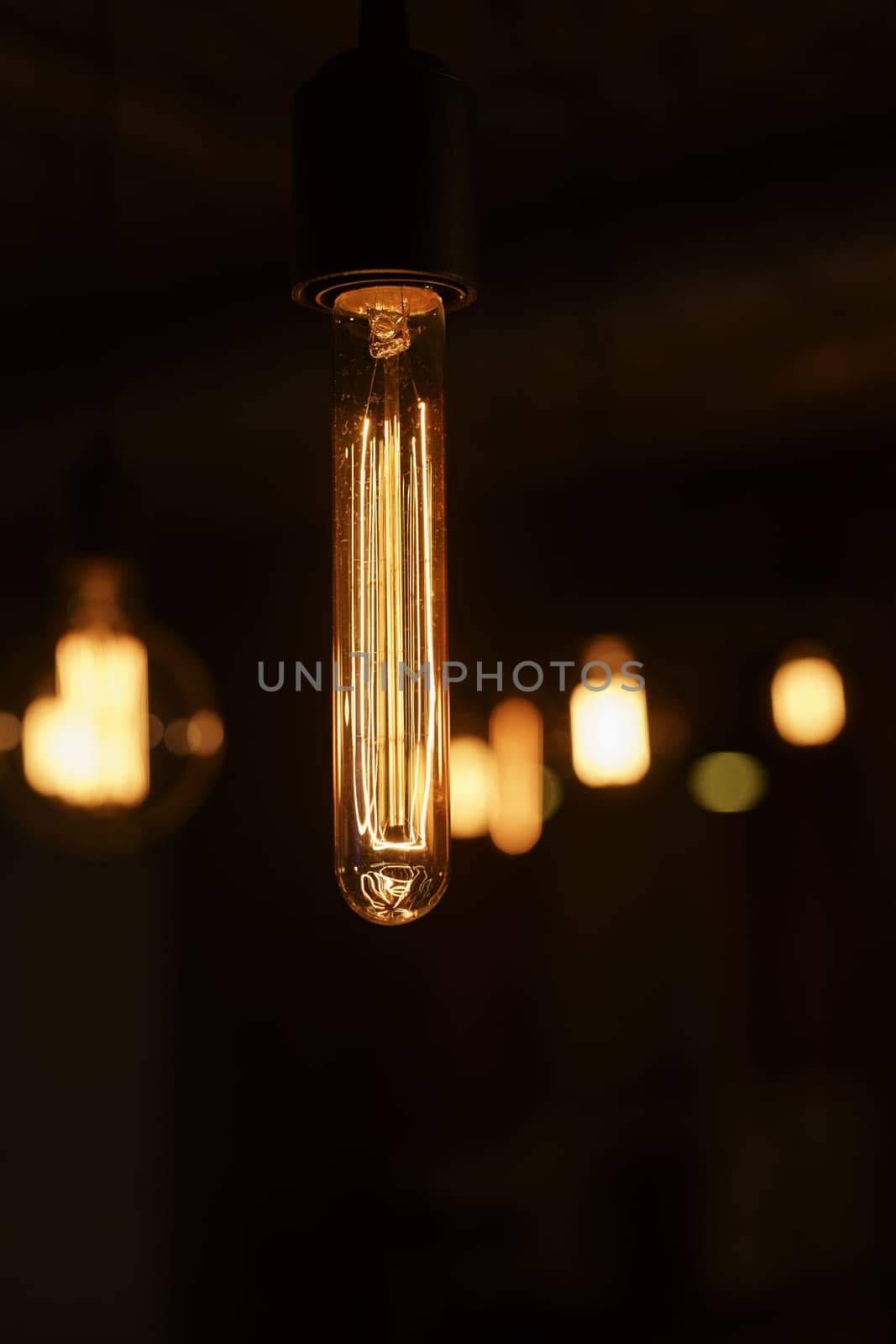 Image of elongated incandescent lamp, blur on background