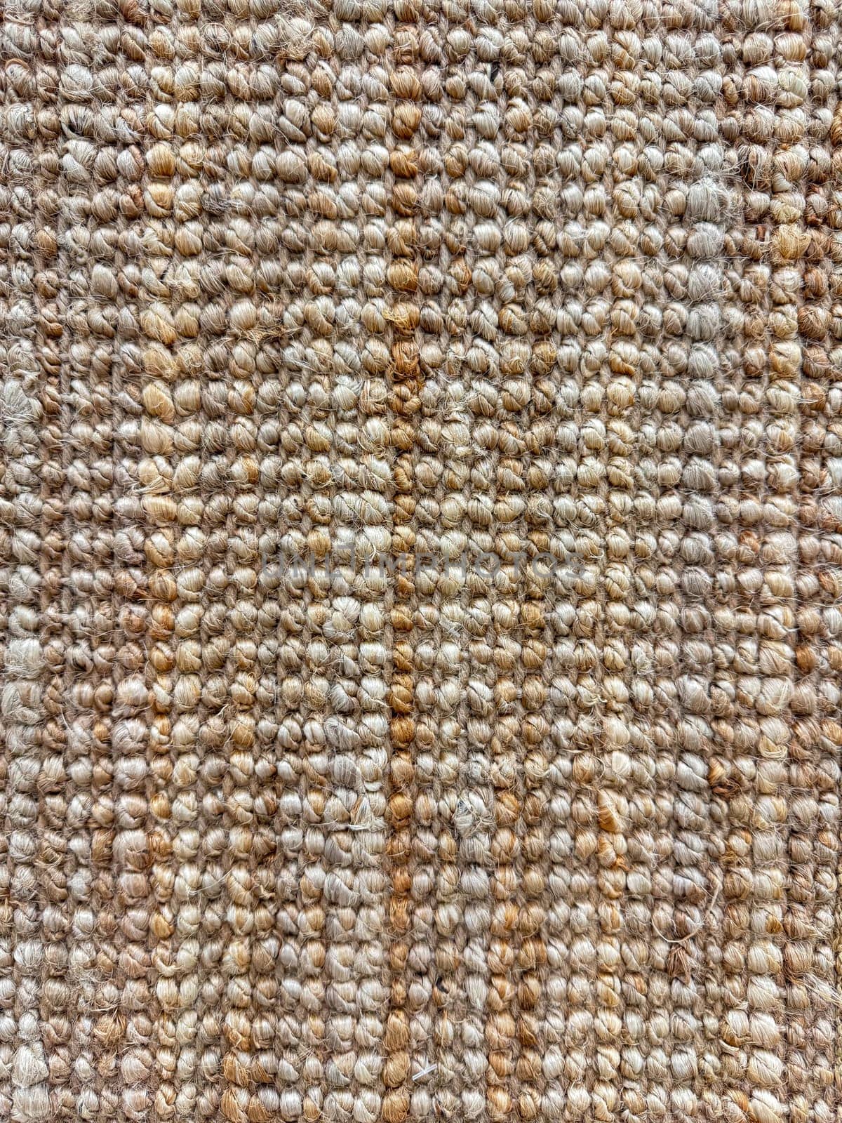 Macro shot of textured jute rug with natural beige and brown tones for interior design and home decor. by Lunnica