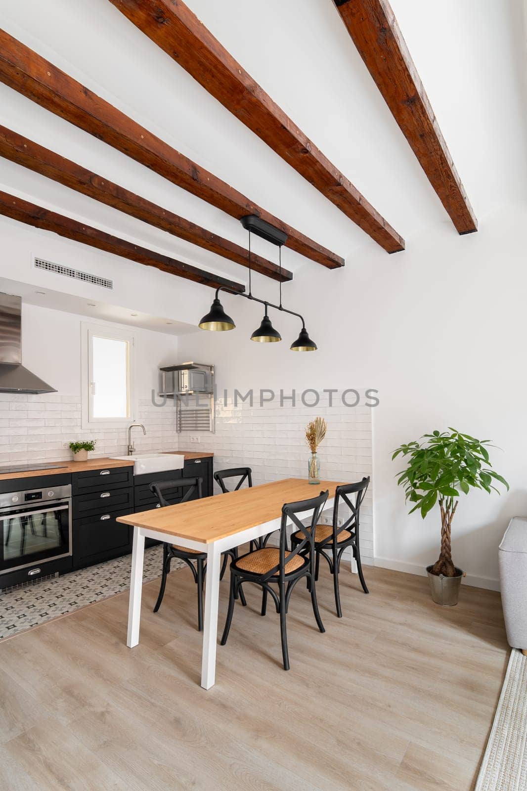 Dining table with wooden surface and chairs in kitchen by apavlin