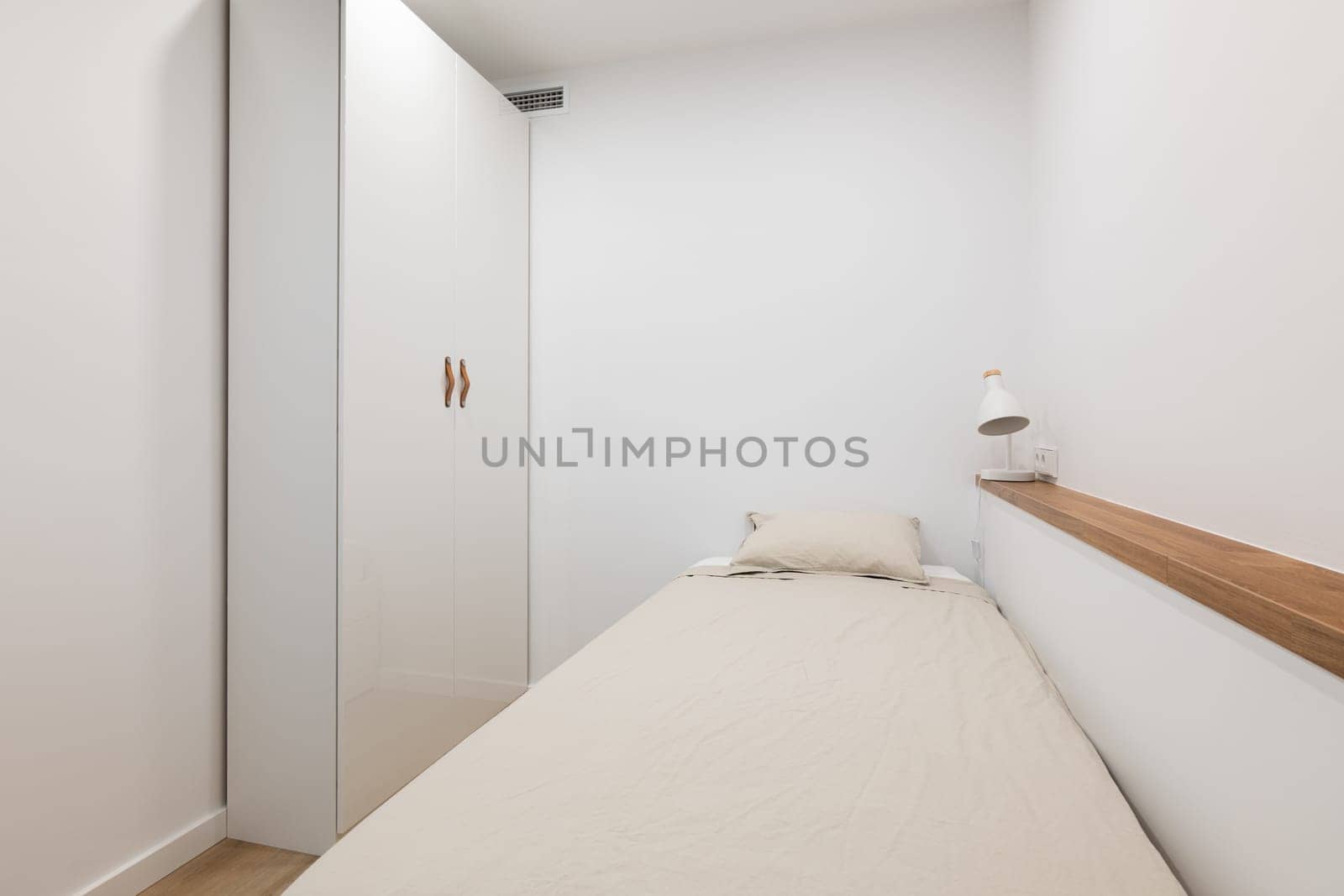 Soft bed with pillow and wardrobe in white color bedroom by apavlin