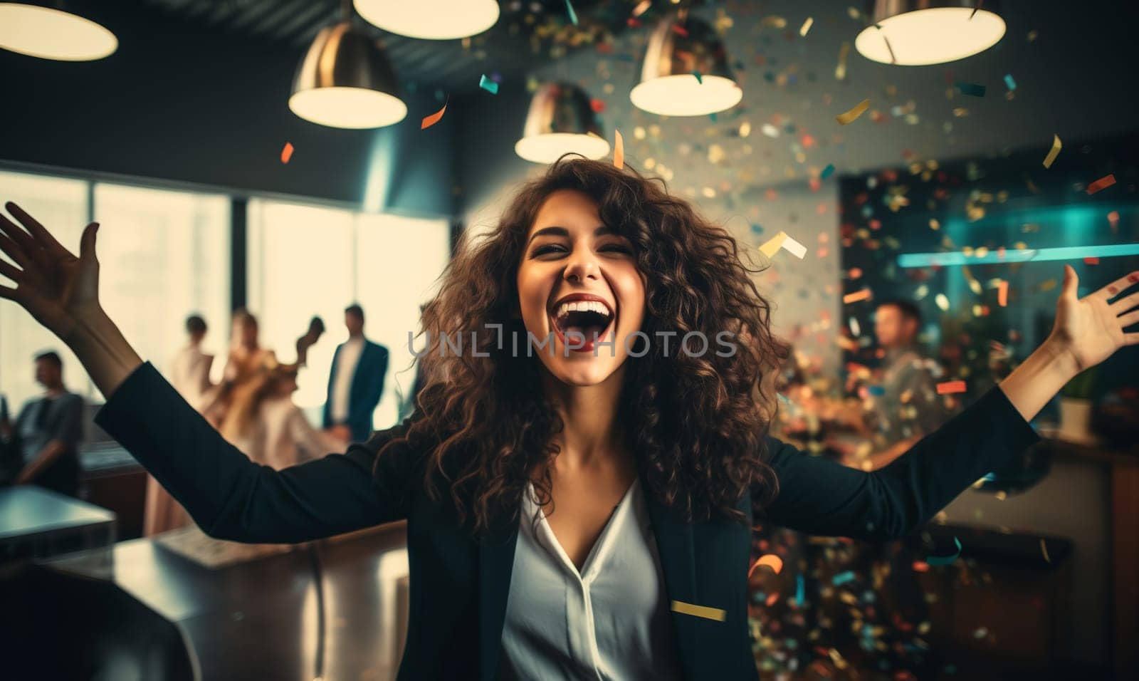 Joyful businesswoman celebrating with her colleagues business people having a party having fun in the office
