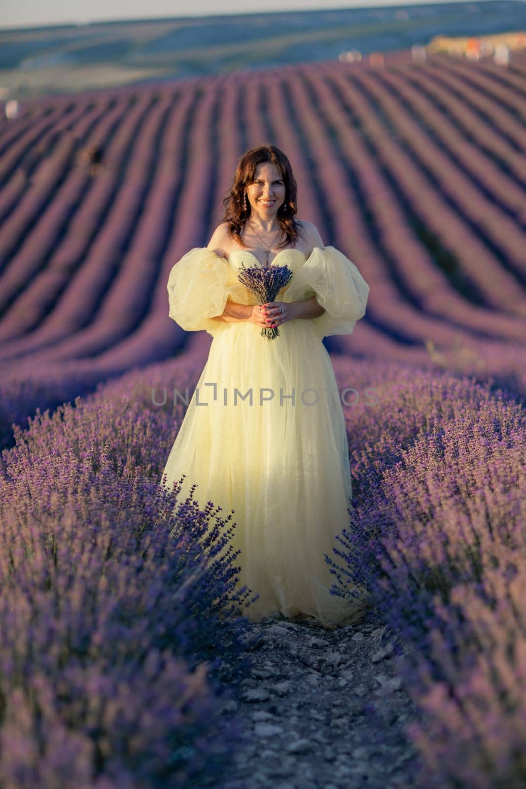Woman lavender field. happy woman in yellow dress in lavender field summer time at sunset. Aromatherapy concept, lavender oil, photo session in lavender.