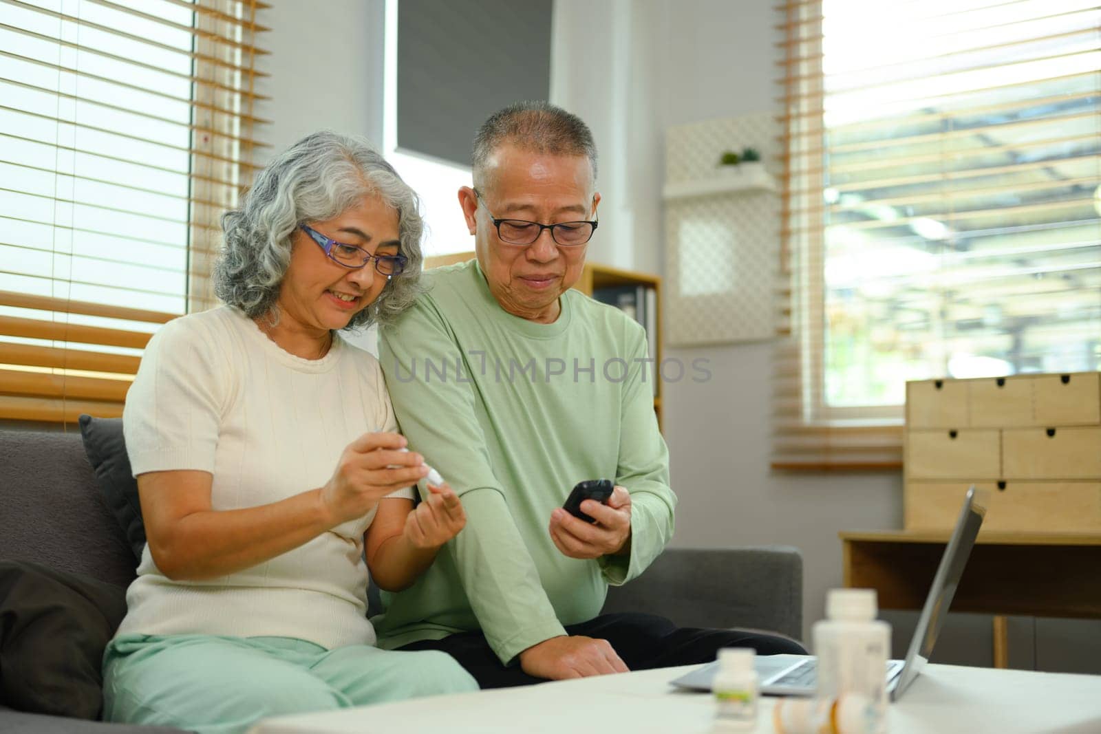 Mature couple having online medical consultation with doctor on laptop. Telehealth concept.