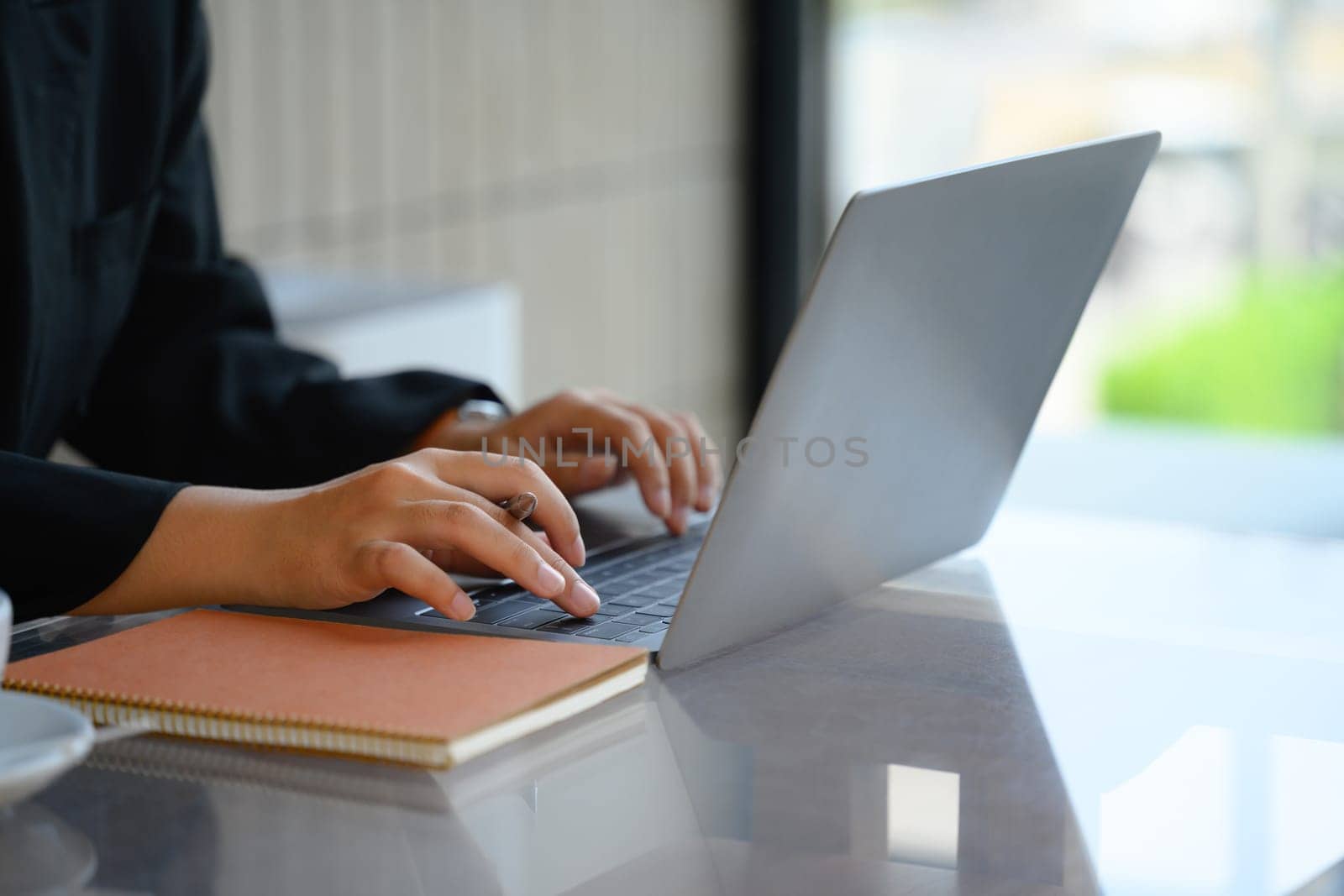 Closeup image of businesswoman hands typing on laptop surfing the internet or online working.