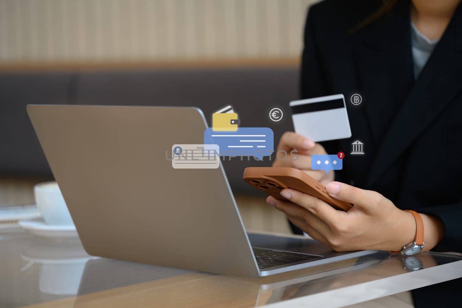 Businesswoman holding credit card and using mobile phone for doing online banking transaction.