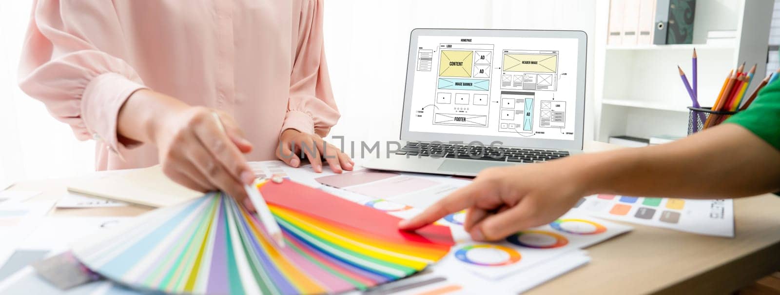 Designer chooses color while laptop displayed website designs Variegated. by biancoblue
