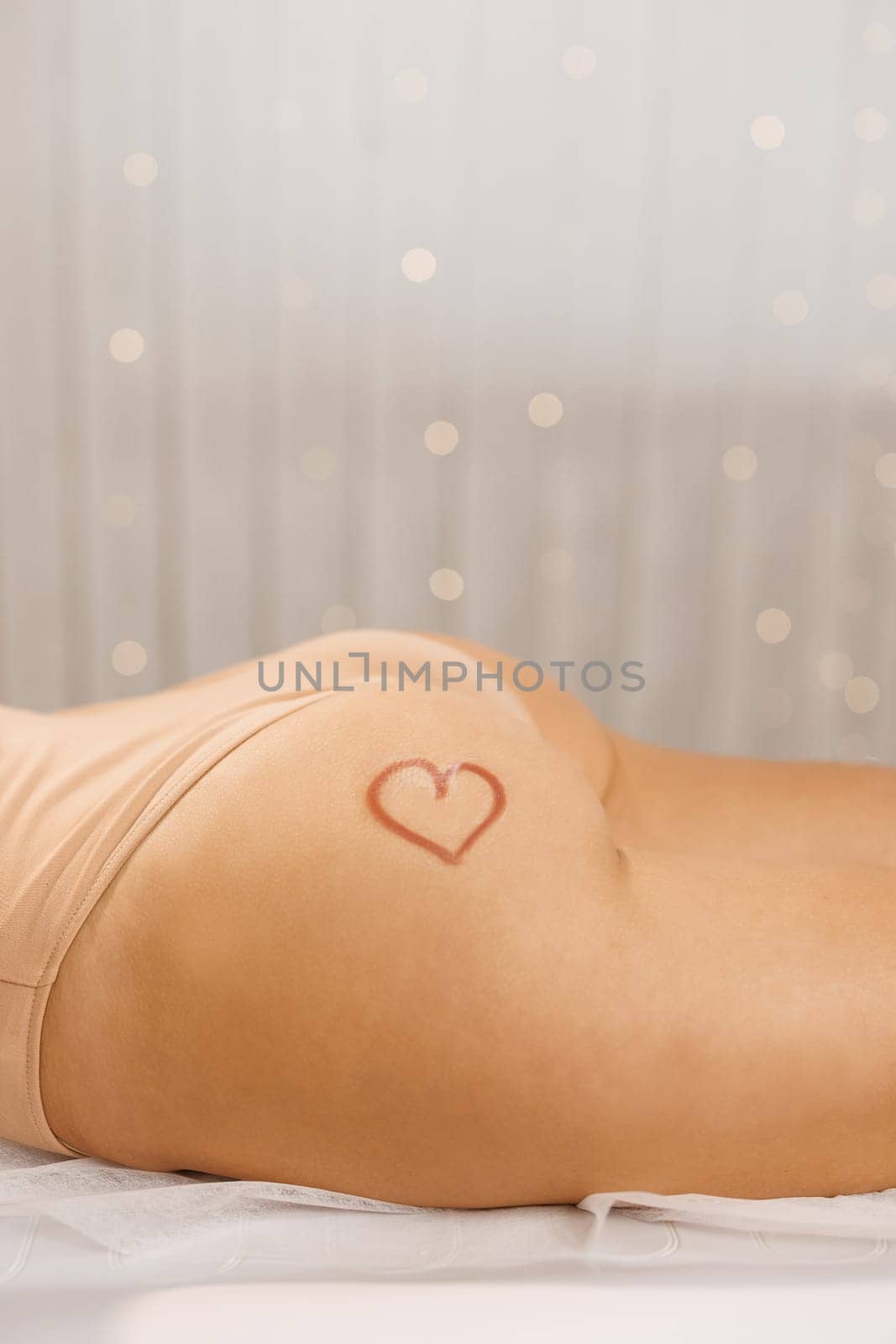 Sexy butt girls in underwear. Sexy womans butt with drawn red heart. Skin care. Spa and laser hair removal. Beautiful female legs after depilation with smooth shiny skin by uflypro