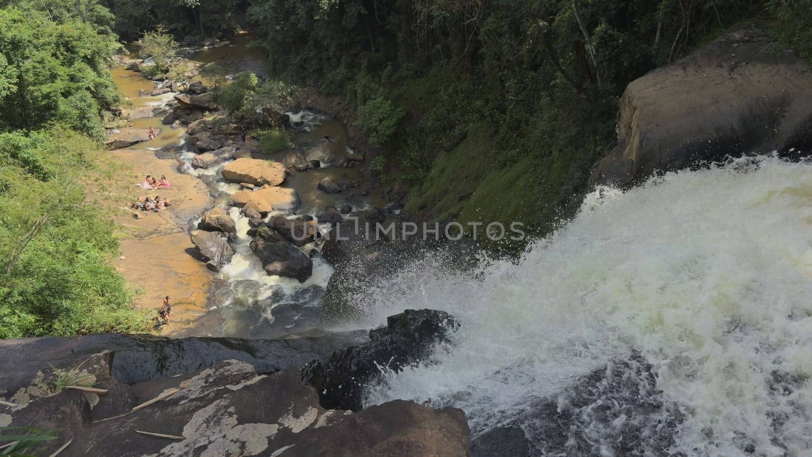 Slow Motion of Waterfall in Jungle with People Bathing by FerradalFCG