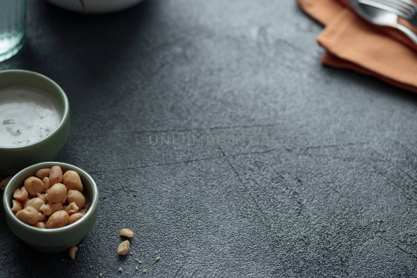 Empty space on the grey stone table with sauce bowls on dark background with space for text. Horizontal