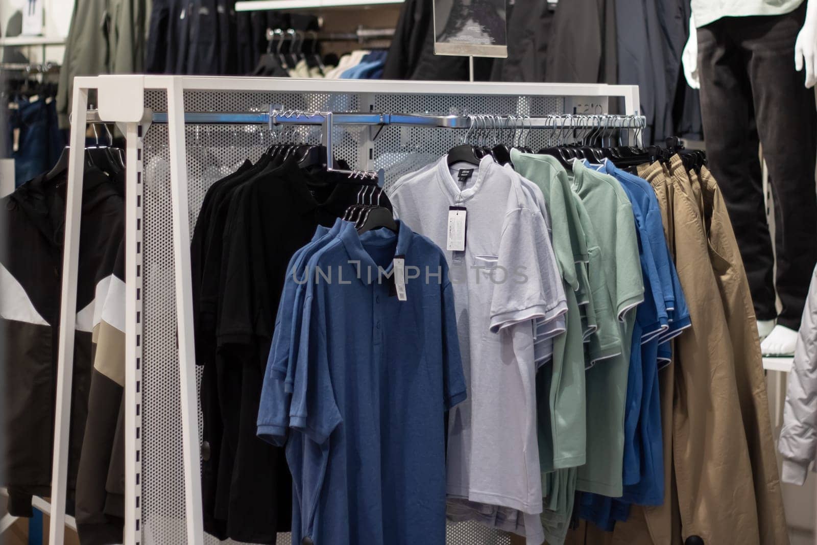 a row of shirts are hanging on a rack in a store by Vera1703